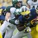 Michigan running back Fitzgerald Toussaint is tackled by Michigan State defenders on Saturday. Daniel Brenner I AnnArbor.com